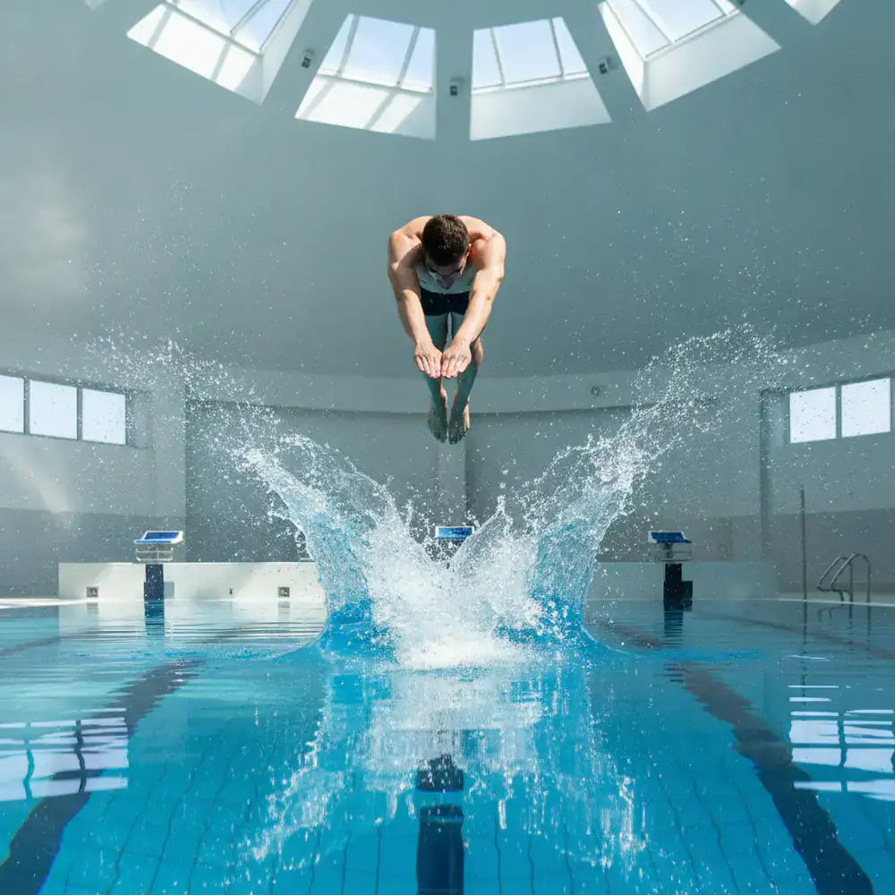 Swimmer diving into a competitive pool